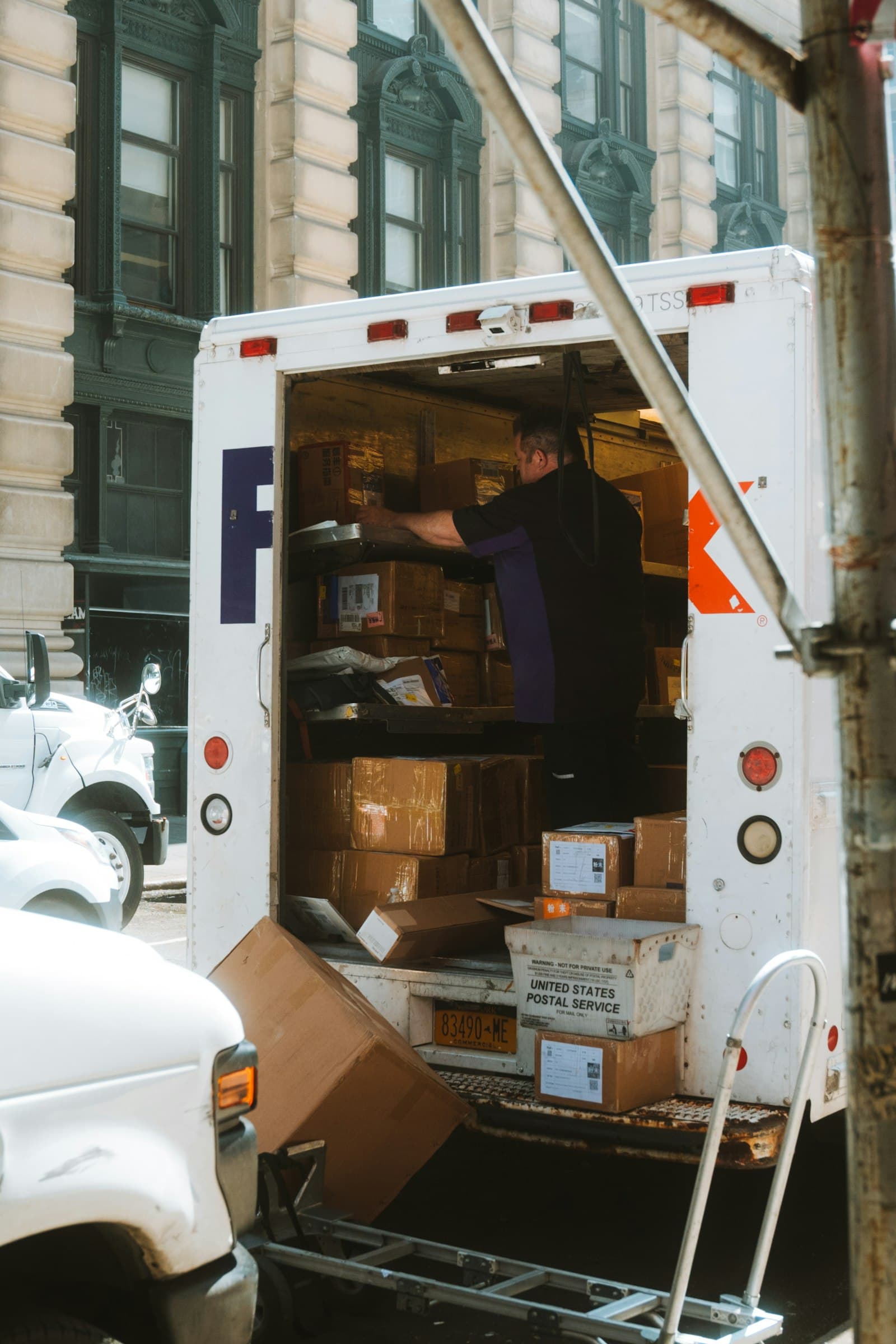 Boxes being loaded into the back of a moving truck.
